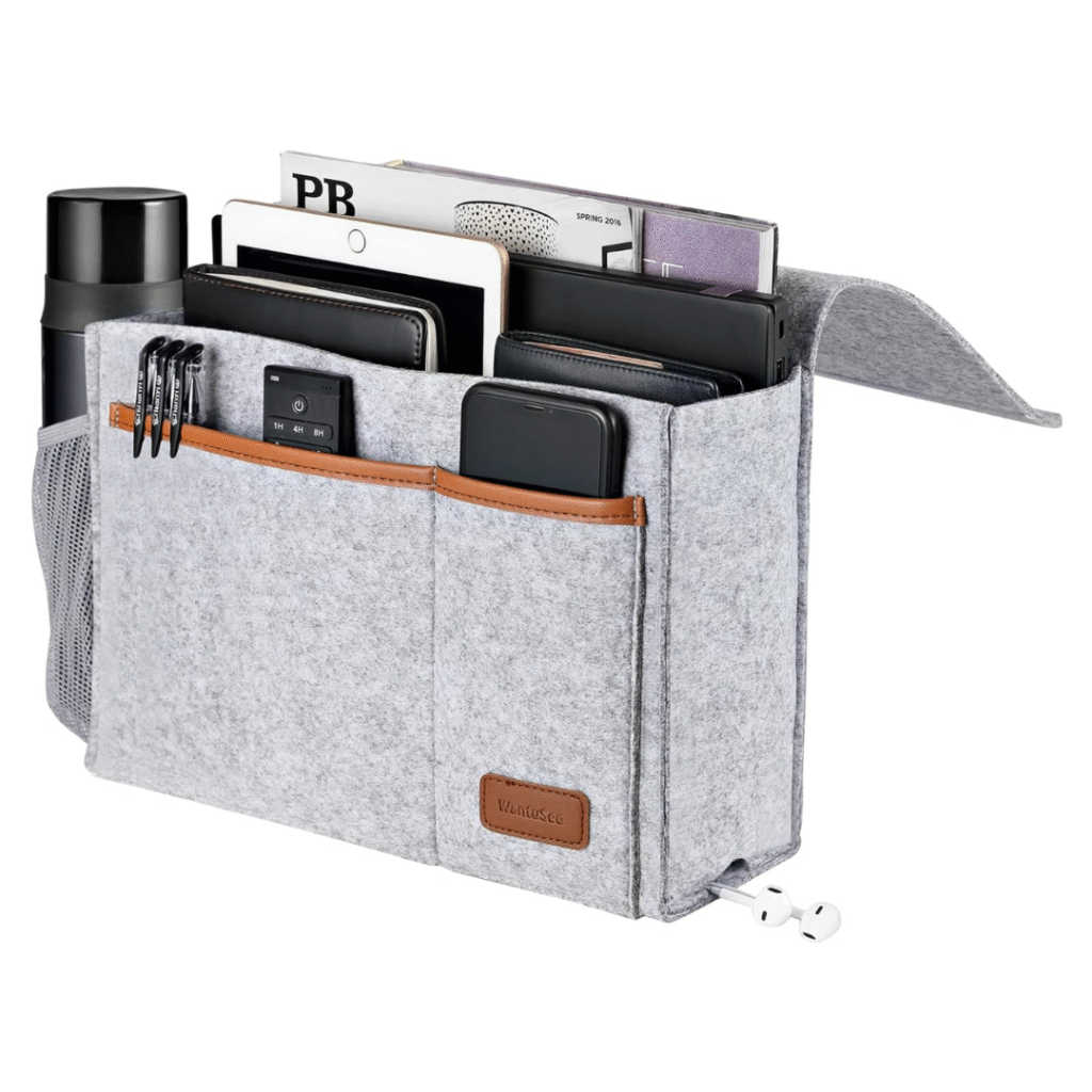 Light gray felt bedside storage caddy with pockets for books, tablet, phone and remote